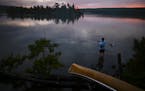 Aidan Jones caught a smallmouth bass while wading in the water off a South Lake campsite Tuesday night. ] Aaron Lavinsky ¥ aaron.lavinsky@startribune