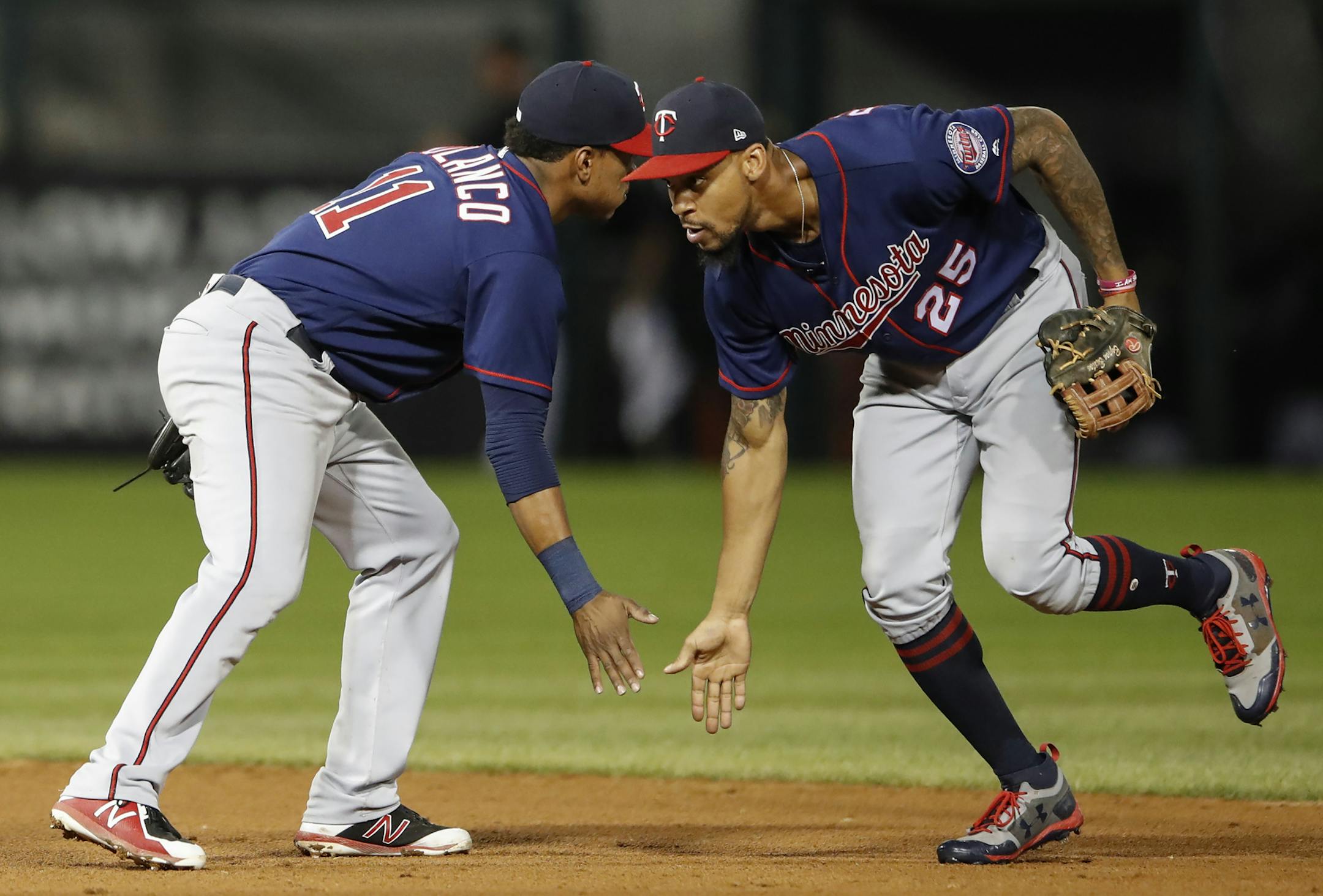 Minnesota Twins' Jorge Polanco (11) celebrates a win agains the Chicago White Sox with Byron Buxton (25) after game two of a baseball doubleheader, Monday, Aug. 21, 2017, in Chicago. (AP Photo/Kamil Krzaczynski)