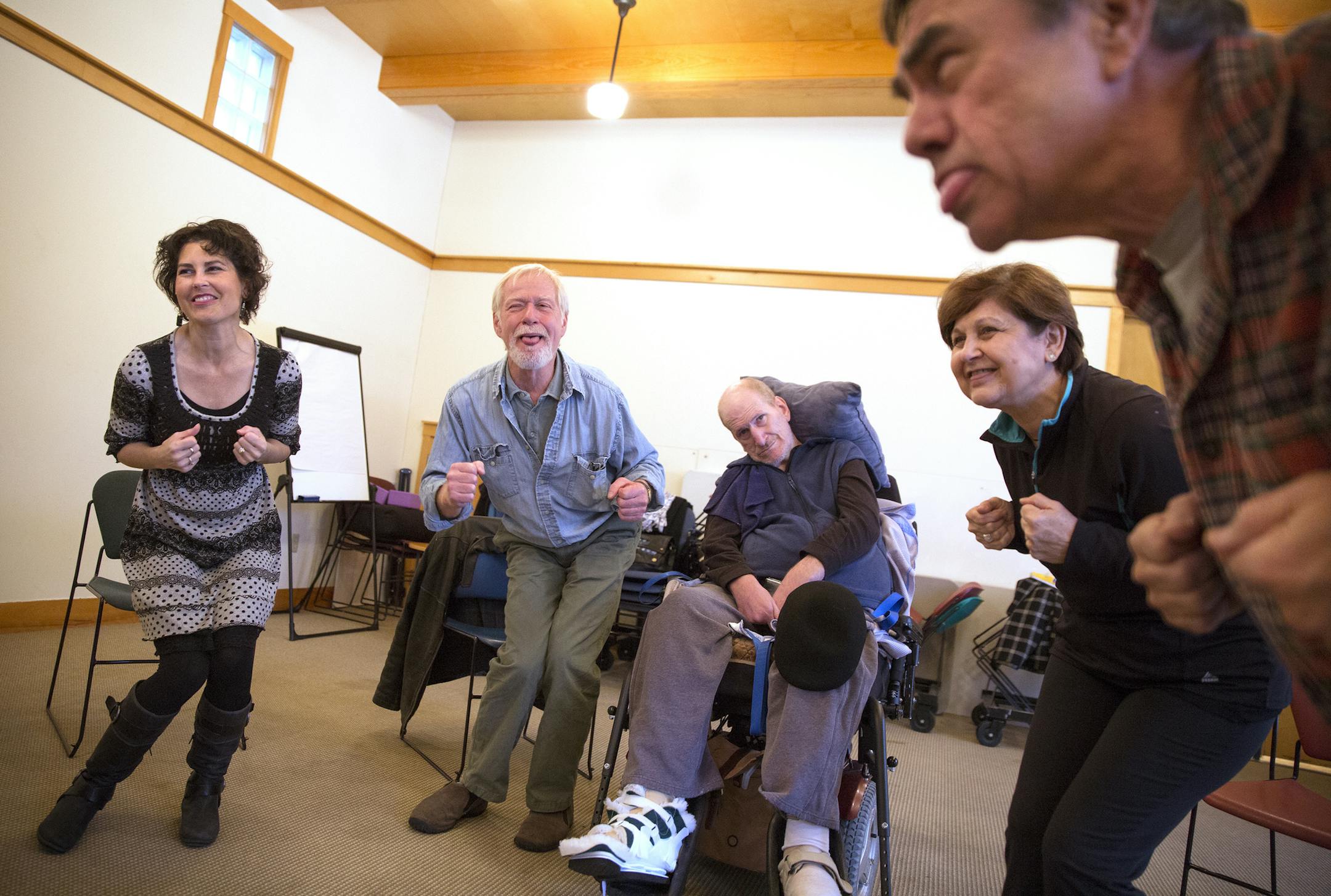 Ilsa Bruins, from left, Vance Gellert, Tom Peilen, Dee Rasmusson and Jim Bilot participate in Laughter Yoga at Pathways Minneapolis on Monday.