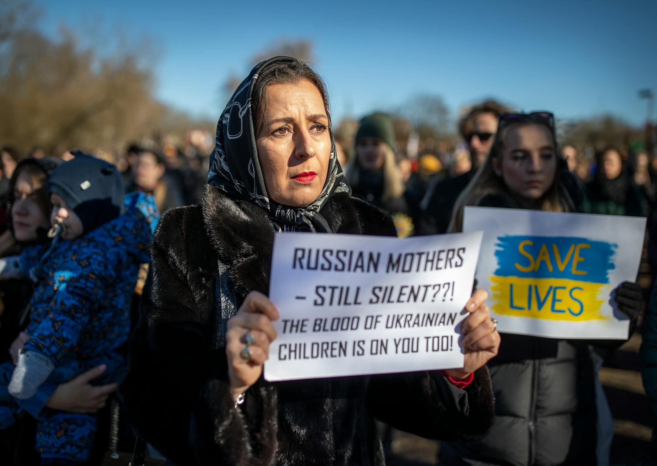 Women take part in a protest against the Russian invasion of Ukraine, in front of the Russian embassy in Vilnius, Lithuania, Sunday, Feb. 27, 2022. Street fighting broke out in Ukraine's second-largest city and Russian troops squeezed strategic ports in the country's south as the prospect of peace talks remains uncertain. (AP Photo/Mindaugas Kulbis)