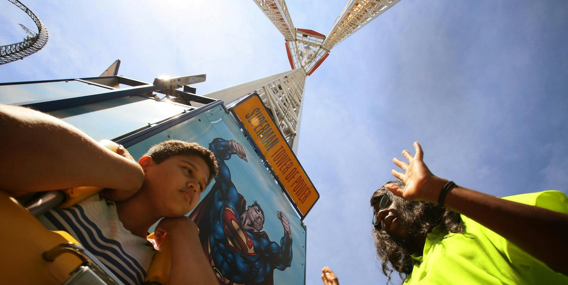 Ride attendant Khadijah Ester, 18, prepares Joseph Maynes to ride the Superman: Tower of Power ride at Six Flags over Texas in Arlington, Texas, on June 7, 2013. (Nathan Hunsinger/Dallas Morning News/MCT)