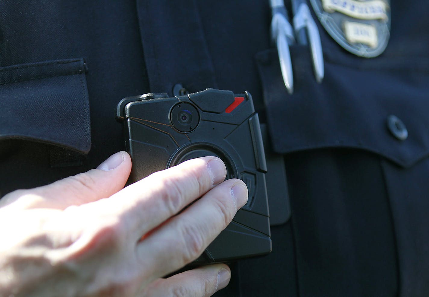 Columbia Heights police officer Terry Nightingale made sure to turn on his body cam before approaching a pedestrian for dangerously crossing the street, Friday, April 17, 2015 in Columbia Heights, MN. ] (ELIZABETH FLORES/STAR TRIBUNE) ELIZABETH FLORES &#x2022; eflores@startribune.com