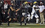 Michigan running back Jabrill Peppers (5) runs away from Rutgers defenders during the first half of an NCAA college football game Saturday, Oct. 8, 20
