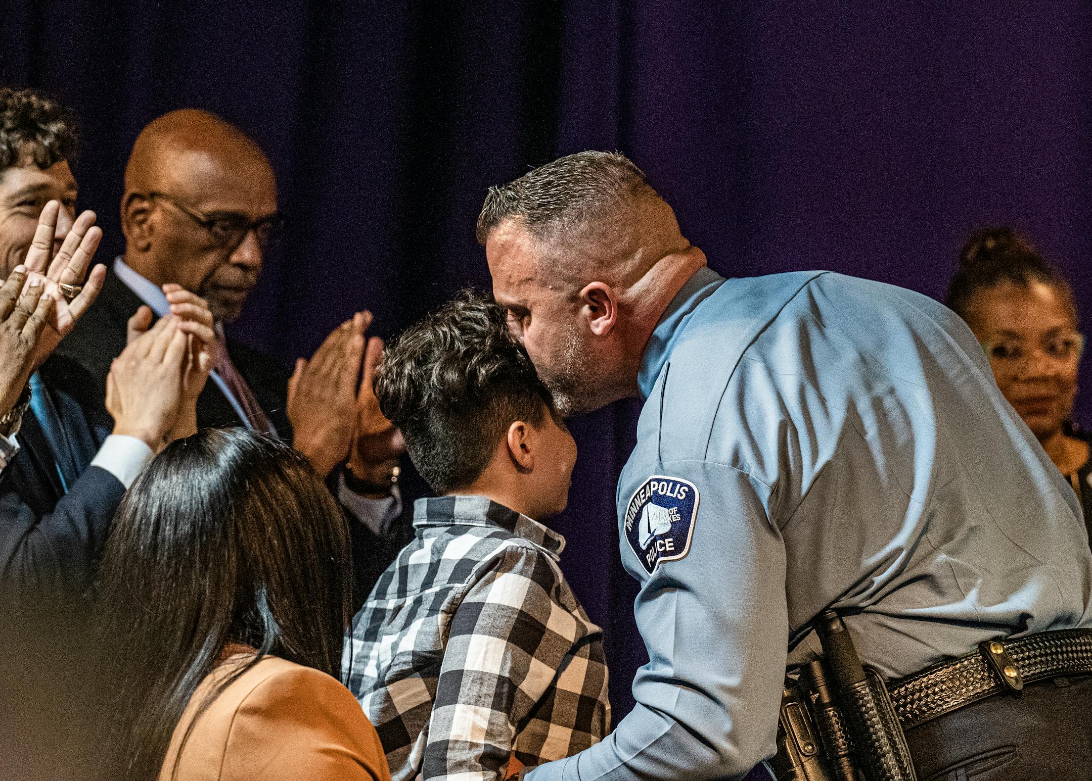 Brian O'Hara kisses son Brendan ,11, after he is sworn as as the new Minneapolis Chief of Police.