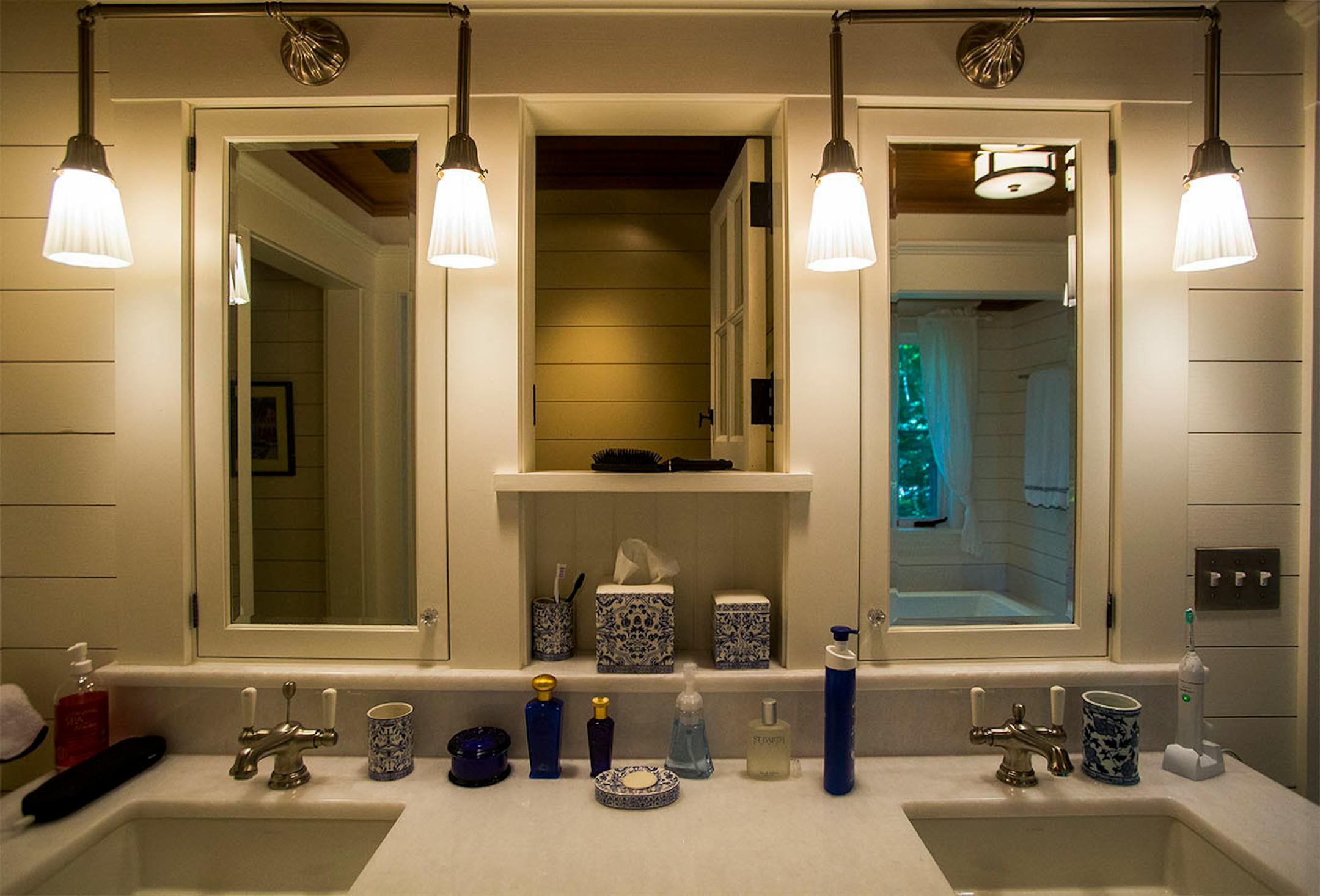 The master bathroom blends simplicity and sleekness with dual sinks and mirrors lit by energy-efficient fixtures.