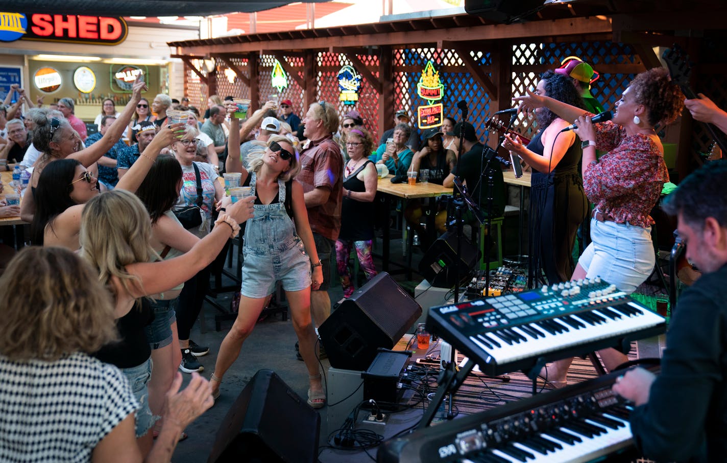 The Sam Juusisto Band got the crowd dancing, including Brittany Christenson, of Minneapolis (in sunglasses), singing "Raise Your Glass" by Pink at the Dino's Bar Shed.