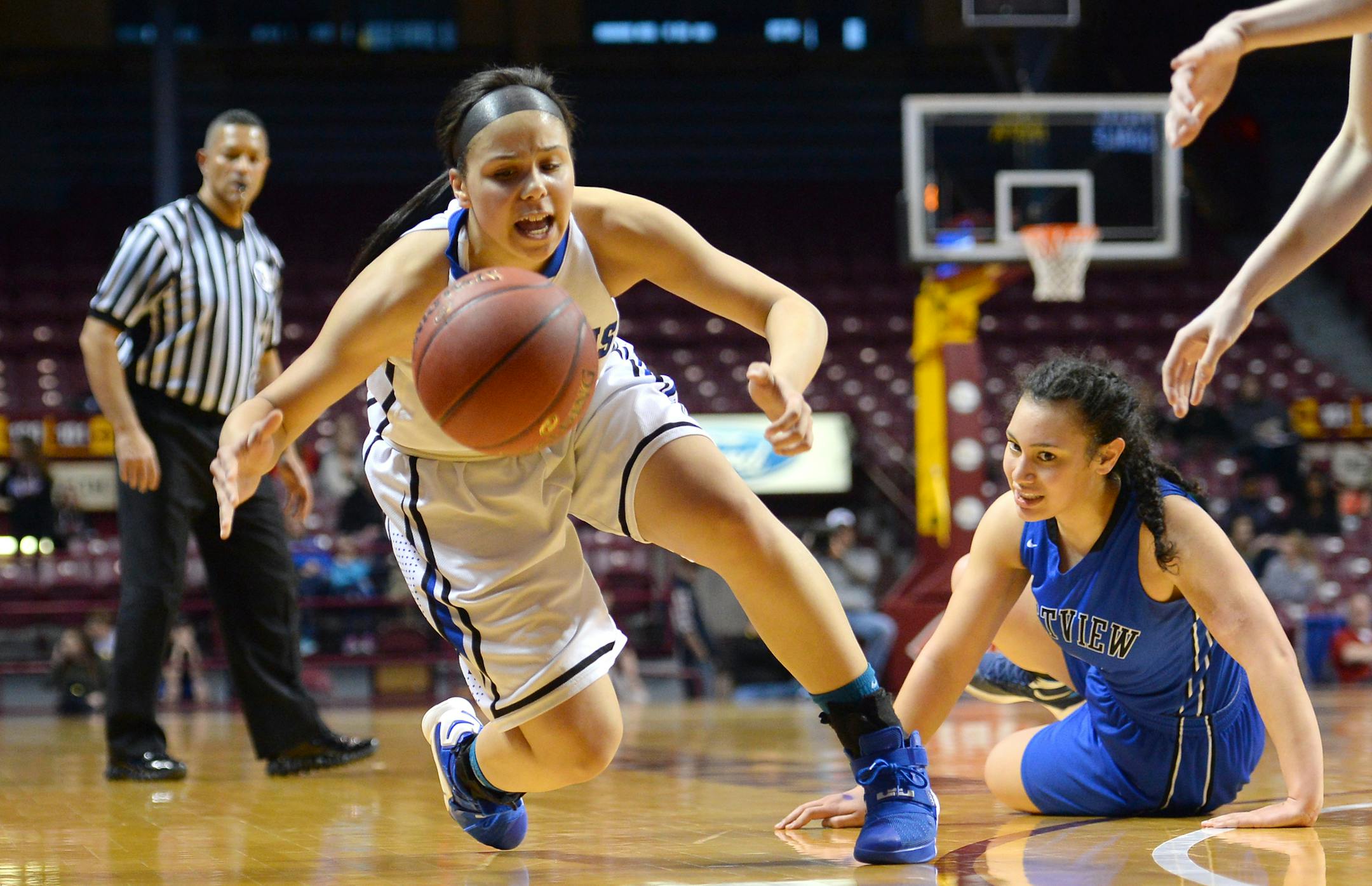 Hopkins guard Ashley Bates (14) dove for a ball knocked loose from Eastview forward Mariah Alipate (3) in the first half Thursday. ] (AARON LAVINSKY/STAR TRIBUNE) aaron.lavinsky@startribune.com Hopkins played Eastview in the Class 4A girls' basketball semifinals on Thursday, March 17, 2016 at Williams Arena in Minneapolis, Minn.