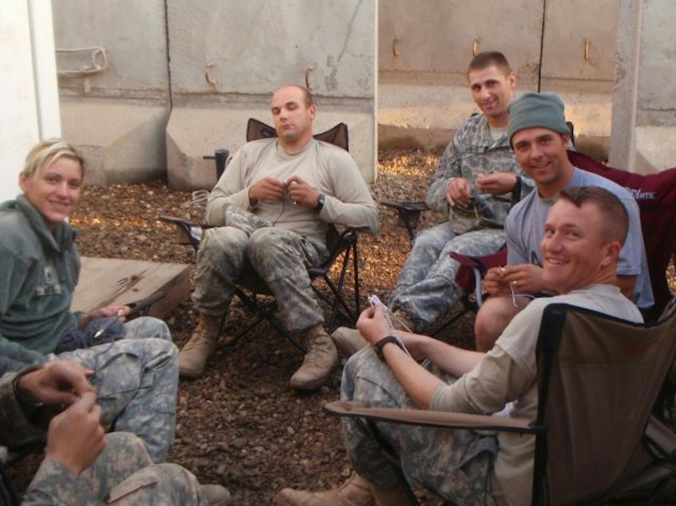 COURTESY JOHN SORICH. Sgt. John Sorich, 26, of Eden Prairie (far right, closest to the camera)taught 10 of his fellow Army Reserves troops how to knit during theirone-year deployment in Iraq. A few of them needed convincing first, but found the skill to be a great stress-reducer.