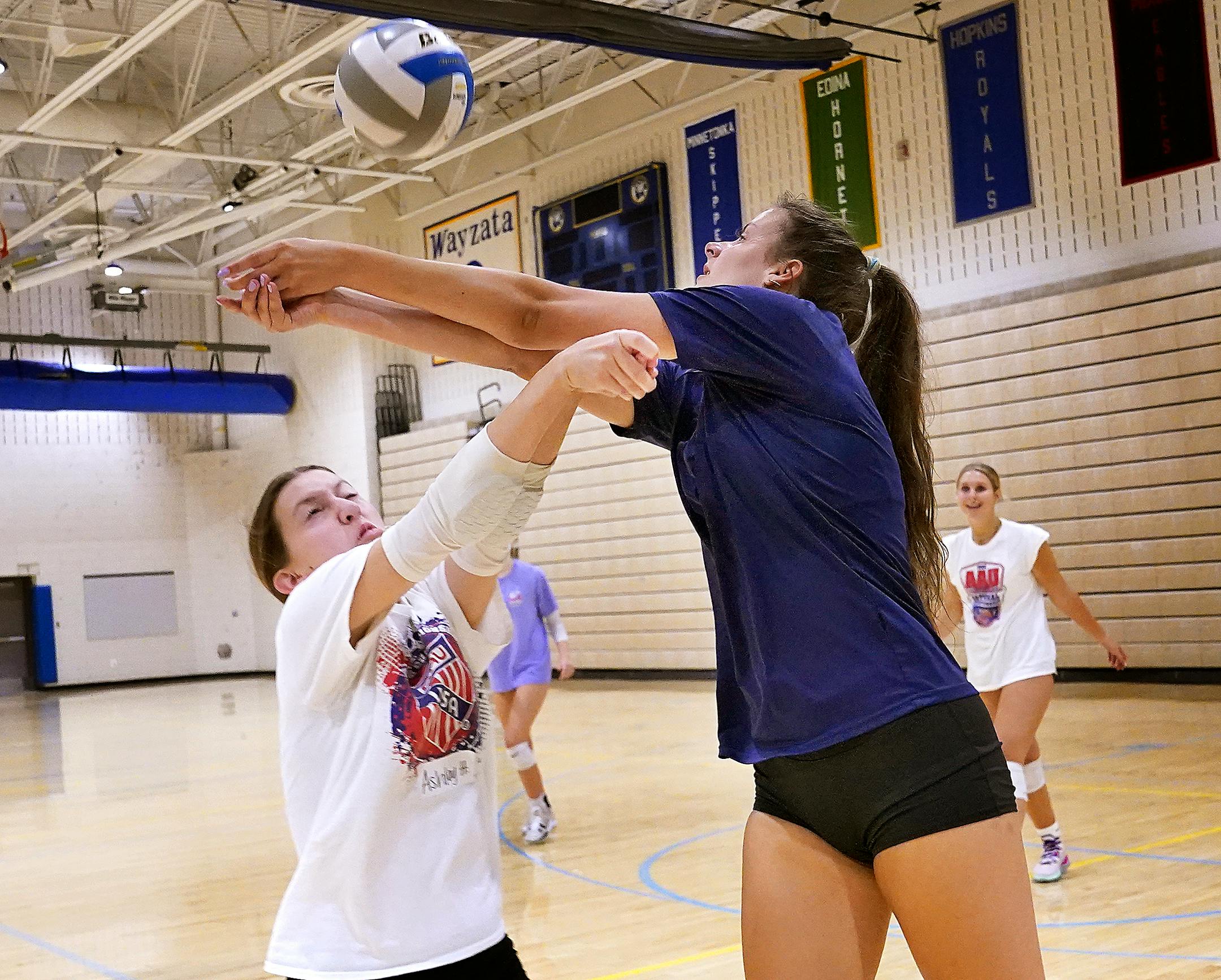 Wayzata High girls volleyball players Stella Swenson, right, and Ashley Hainline collide while competing during practice.