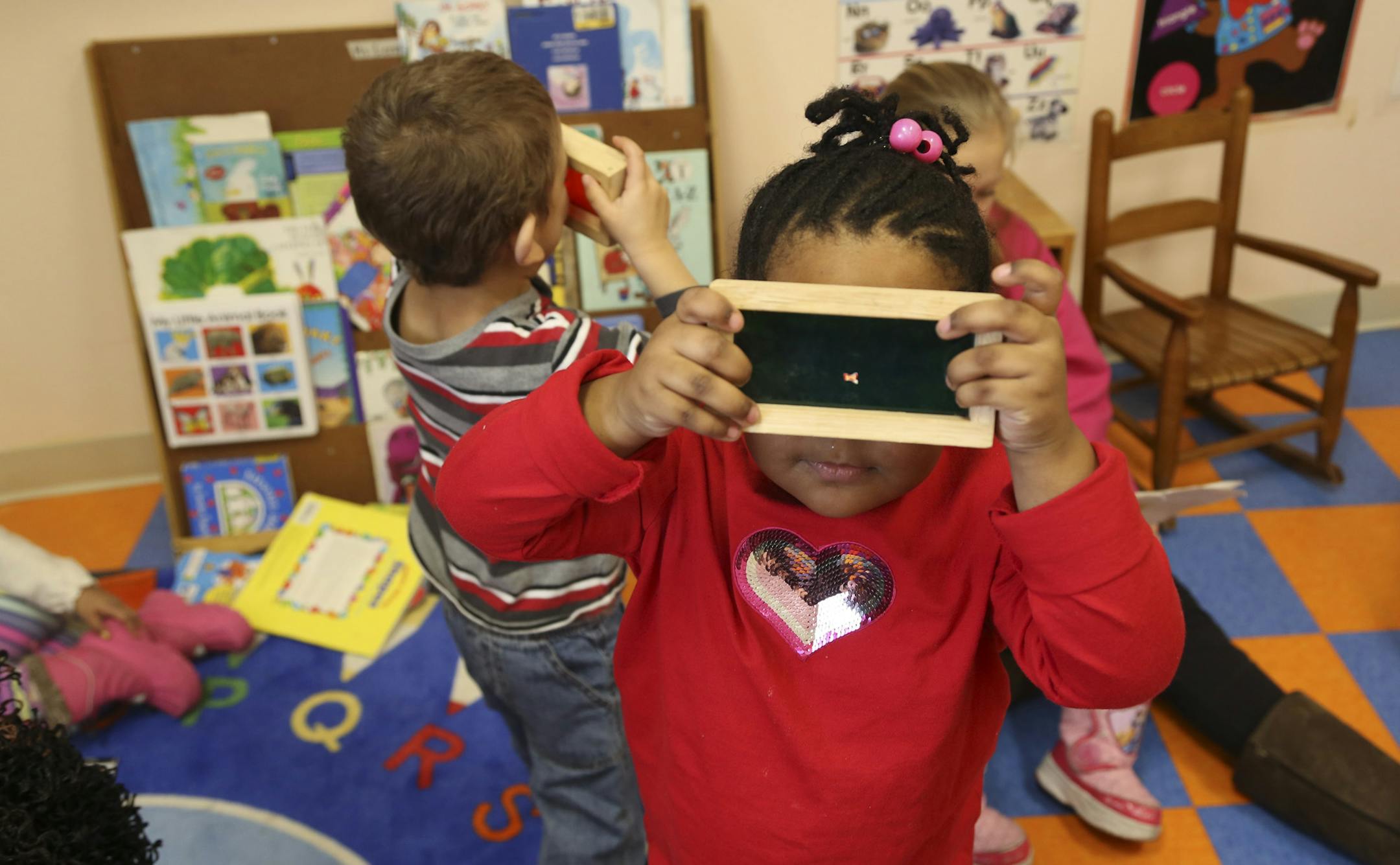 Courtney Morgan, 3, had fun looking through the green block at Family Partnership Child Care Center in Minneapolis , Min.,Wednesday, March 6, 2013. ] (KYNDELL HARKNESS/STAR TRIBUNE) kyndell.harkness@startribune.com