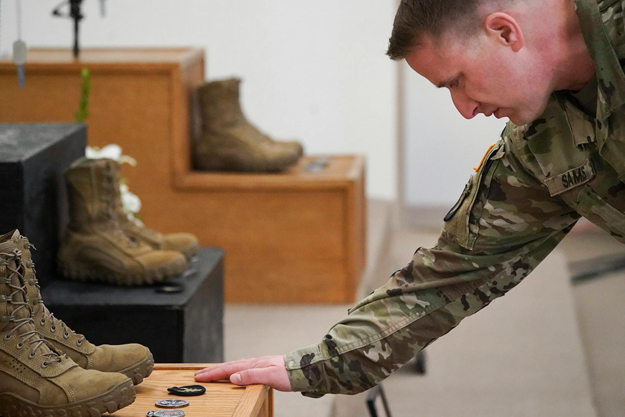Maj. Jordan Sams touched the memorial of Chief Warrant Officer James A Rogers Jr., during a memorial ceremony in North Fort Hood.