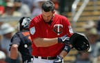 Minnesota Twins first baseman C.J. Cron (24) tosses his helmet after striking out to end the fourth inning of a spring training baseball game against 