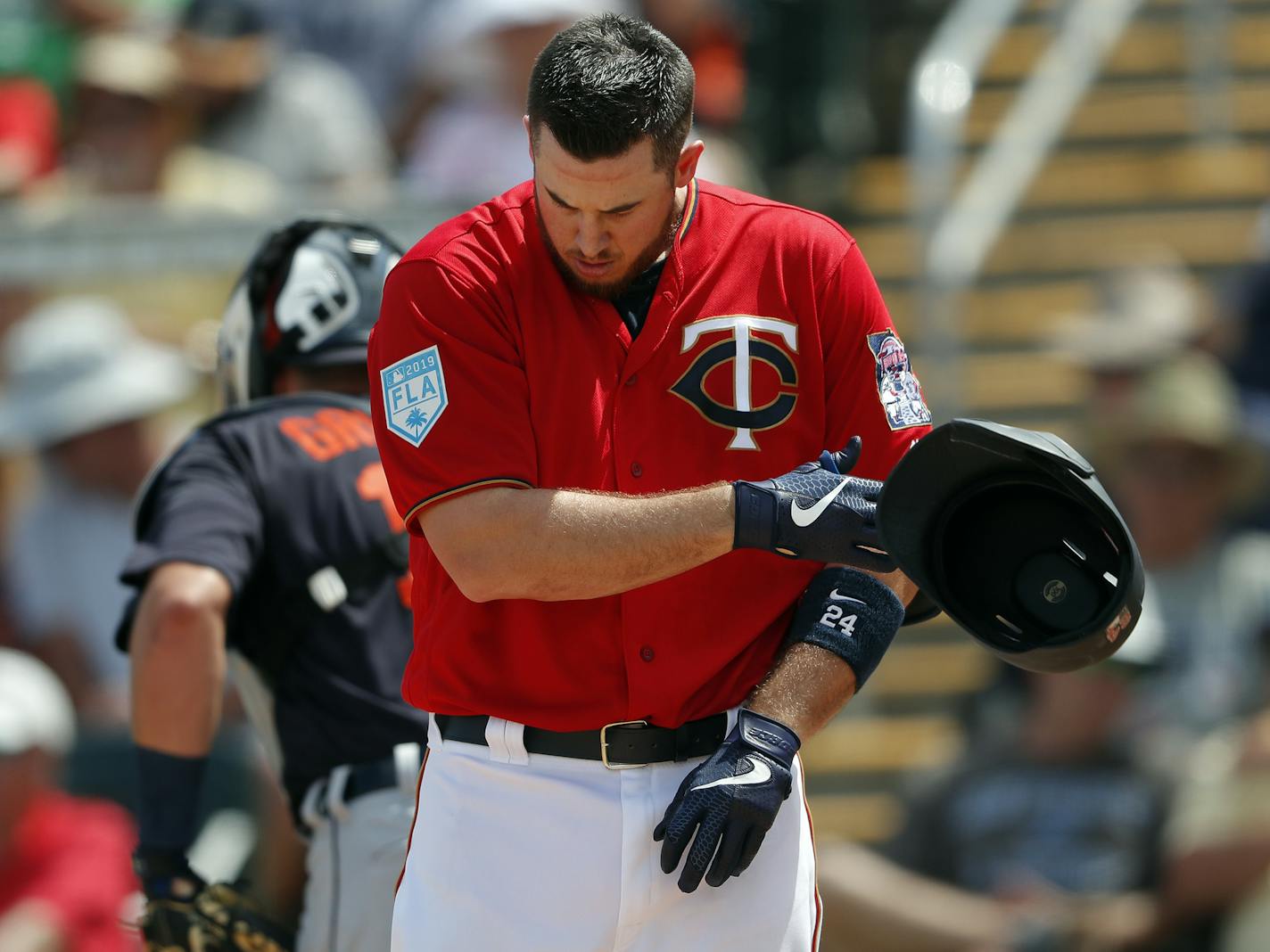 Minnesota Twins first baseman C.J. Cron (24) tosses his helmet after striking out to end the fourth inning of a spring training baseball game against the Detroit Tigers Monday, March 11, 2019, in Fort Myers, Fla. (AP Photo/John Bazemore)