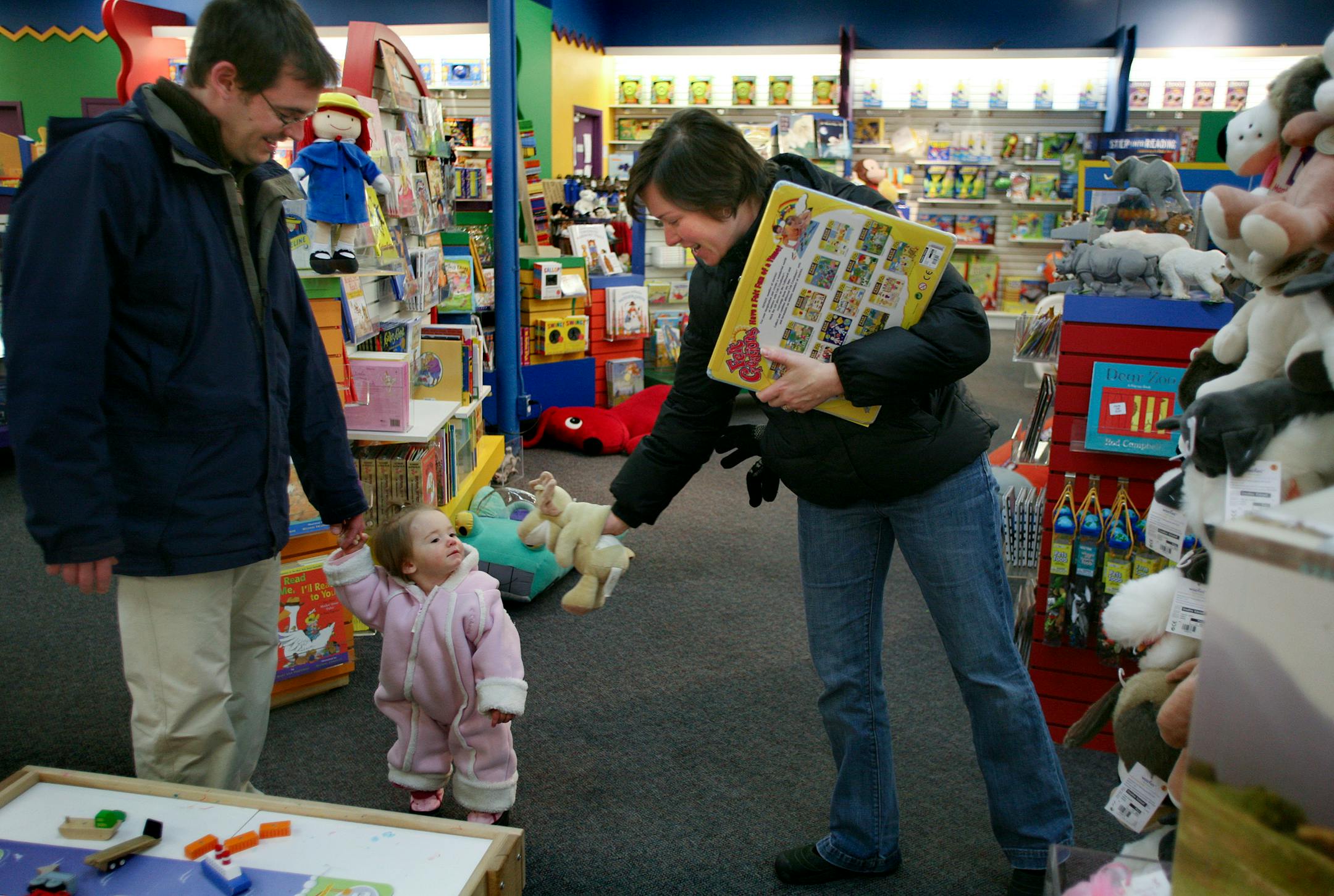 St. Paul residents Rob Slesak, left, and Ann Marie Yacobucci, with their 1-year-old daugther Maya, shopped for Christmas gifts at Creative Kidstuff.