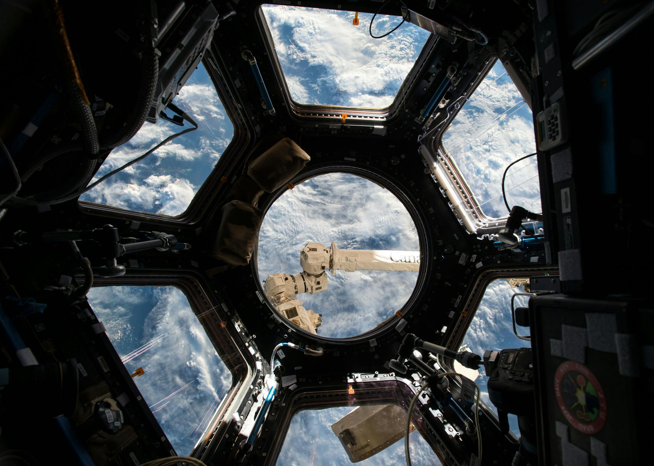 This June 4, 2015 photo made available by NASA shows the Cupola, a 360 degree observation area and remote control location for grappling, docking and undocking spacecraft on the International Space Station. Astronaut Scott Kelly tweeted "Often when I look out the window I think we should call it Planet Water instead of Earth. Sadly mostly saltwater." (Scott Kelly/NASA via AP)