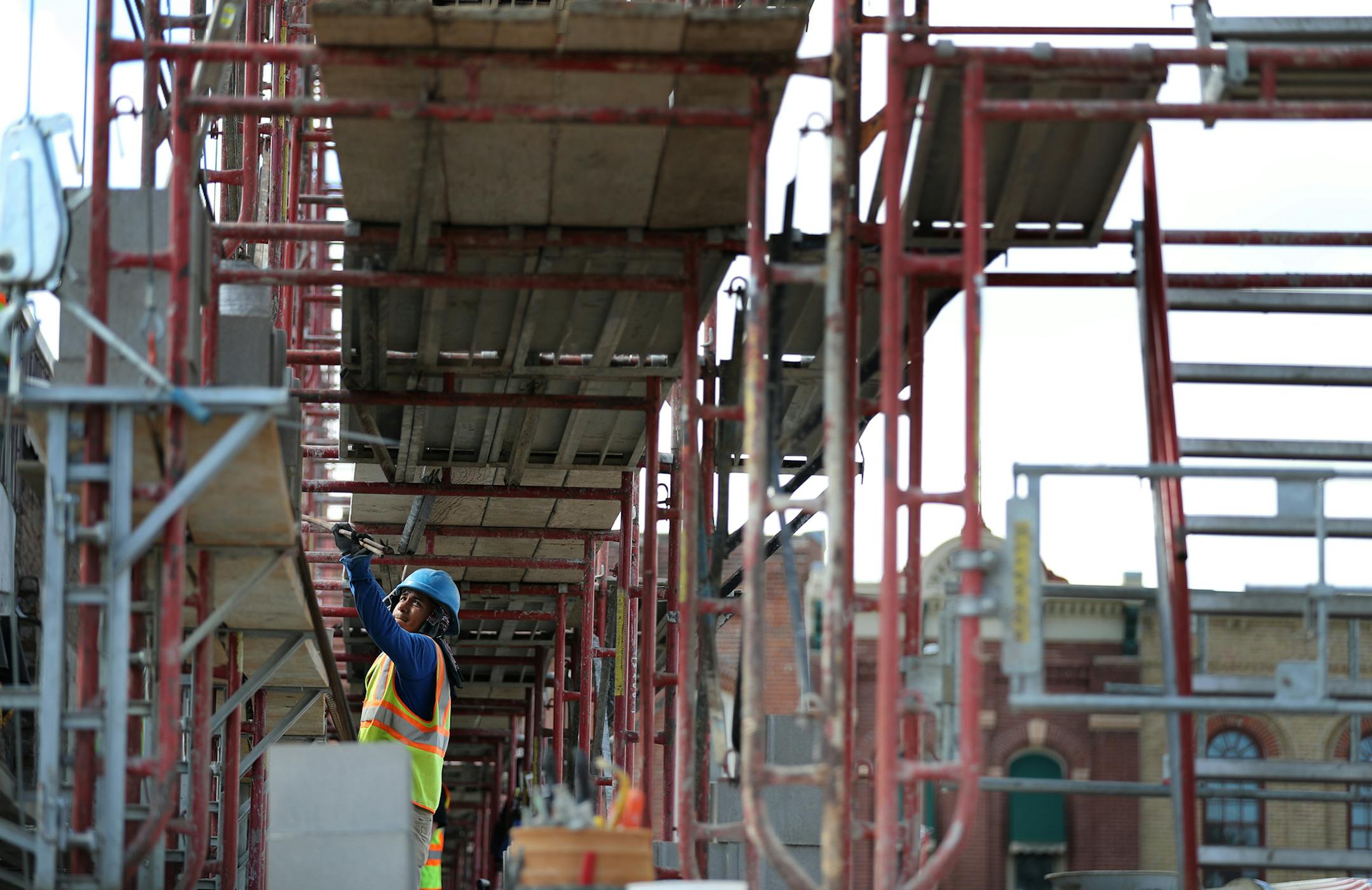 A construction worker works on framing for buildings on Main Street in Madelia. ] (Leila Navidi/Star Tribune) leila.navidi@startribune.com BACKGROUND INFORMATION: Tuesday, June 28, 2016 in Madelia. Madelia is on the rebound, five months after a fire wiped out a section of Main Street and displaced eight businesses. The last remaining business to find a temporary home, a popular Mexican restaurant, has opened at the Madelia County Club. And construction on new buildings along Main Street has begu