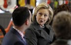 Democratic presidential candidate Hillary Rodham Clinton talks to Brad Magg, left, owner of Goldie&#xed;s Ice Cream Shoppe and Magg Family Catering, d