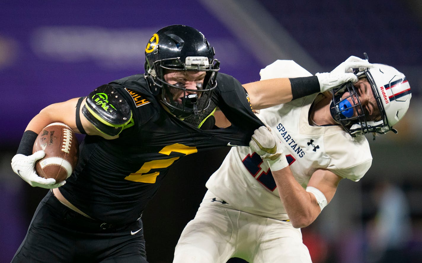 Hutchinson High School fullback Levi Teetzel (2) stiff arms Orono High School cornerback Joey Greenagel (11) in the first half of a 4A football state tournament semi-final game Friday, Nov. 19, 2021 in U.S. Bank Stadium in Minneapolis. ]