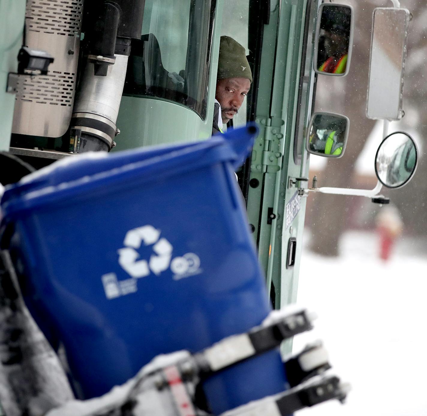 Driver Mourssalou Boukari made a recycling round early Wednesday, January 25, 2017 in St. Paul, MN. The first couple of weeks with new recycling trucks, 80,000 new recycling bins and new recycling pickup days has been frustrating for thousands of St. Paul residents. ] (ELIZABETH FLORES/STAR TRIBUNE) ELIZABETH FLORES &#x2022; eflores@startribune.com