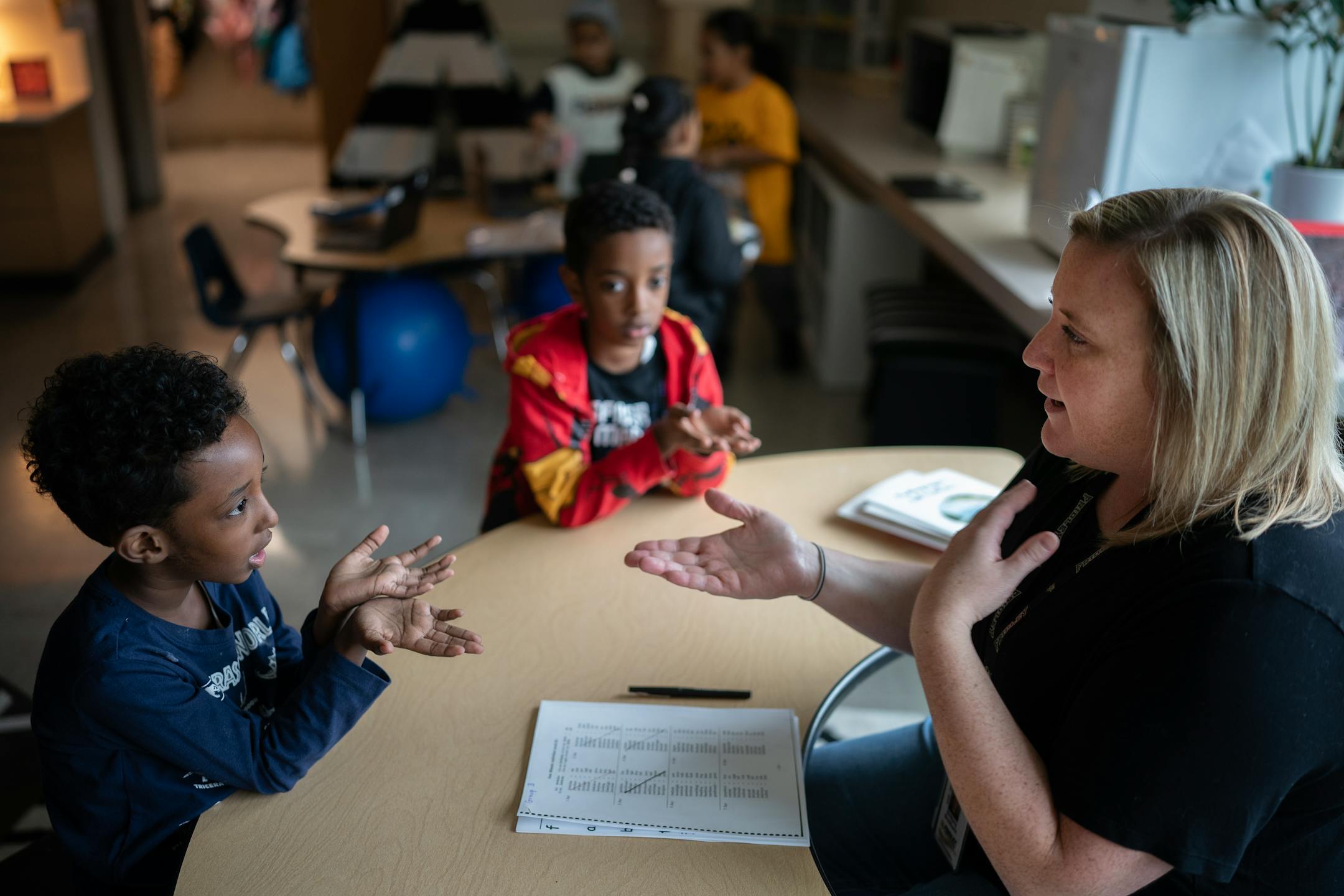 Brit Breitbach teaching reading to her kindergartners twins brothers Hamza Ahmed left and Hudeifa Ahmed, at Stevenson Elementary in Fridley.