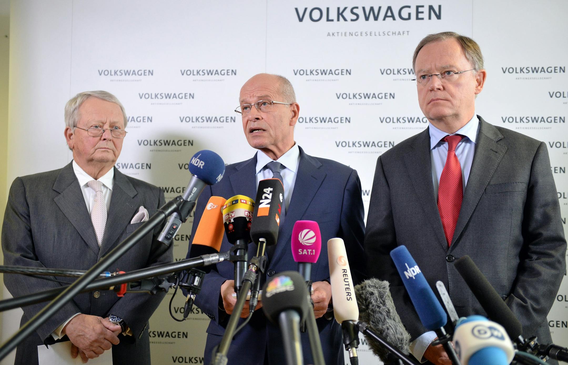 Volkswagen supervisory board member Wolfgang Porsche, acting supervisory board head Berthold Huber, and Stephan Weil, governor of Lower Saxony and member of the supervisory board, from left, give a statement announcing that CEO Martin Winterkorn stepped down amid an emissions scandal in the company's headquarters in Wolfsburg, Germany, Wednesday, Sept. 23, 2015. (Julian Stratenschulte/dpa via AP)