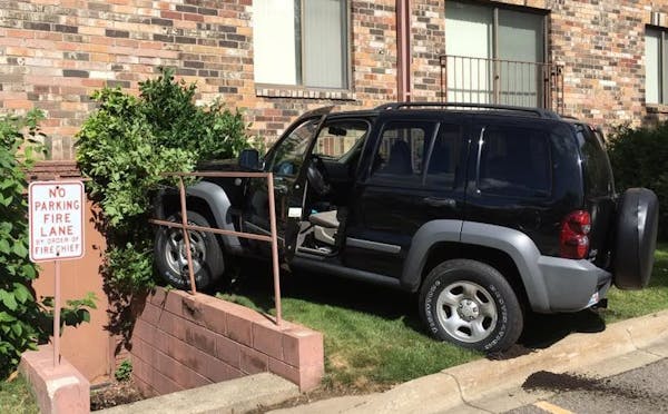 A woman crashed her Jeep Liberty into a Hopkins apartment building just before 10 a.m. Thursday, police said.