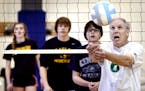 Bob Wandberg tried to hit the ball over the net during a volley ball game with Jefferson High students . A group of senior citizens who call themselve