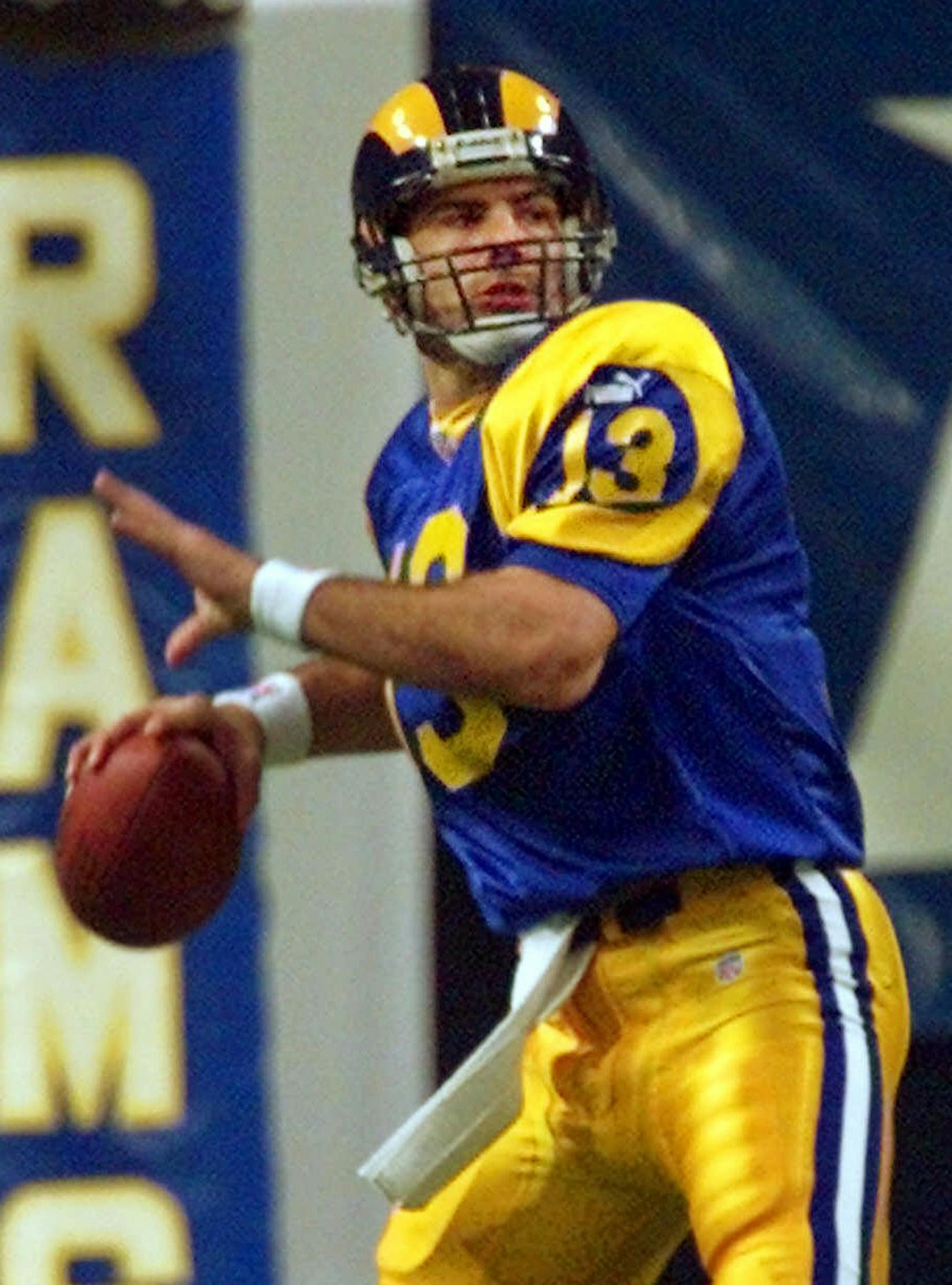 St. Louis Rams quarterback Kurt Warner sets to throw a 77-yard touchdown pass to receiver Isaac Bruce during the first quarter of the NFC divisional playoff game against the Minnesota Vikings Sunday, Jan. 16, 2000, at the Trans World Dome in St. Louis. (AP Photo/J. Pat Carter) ORG XMIT: STR110