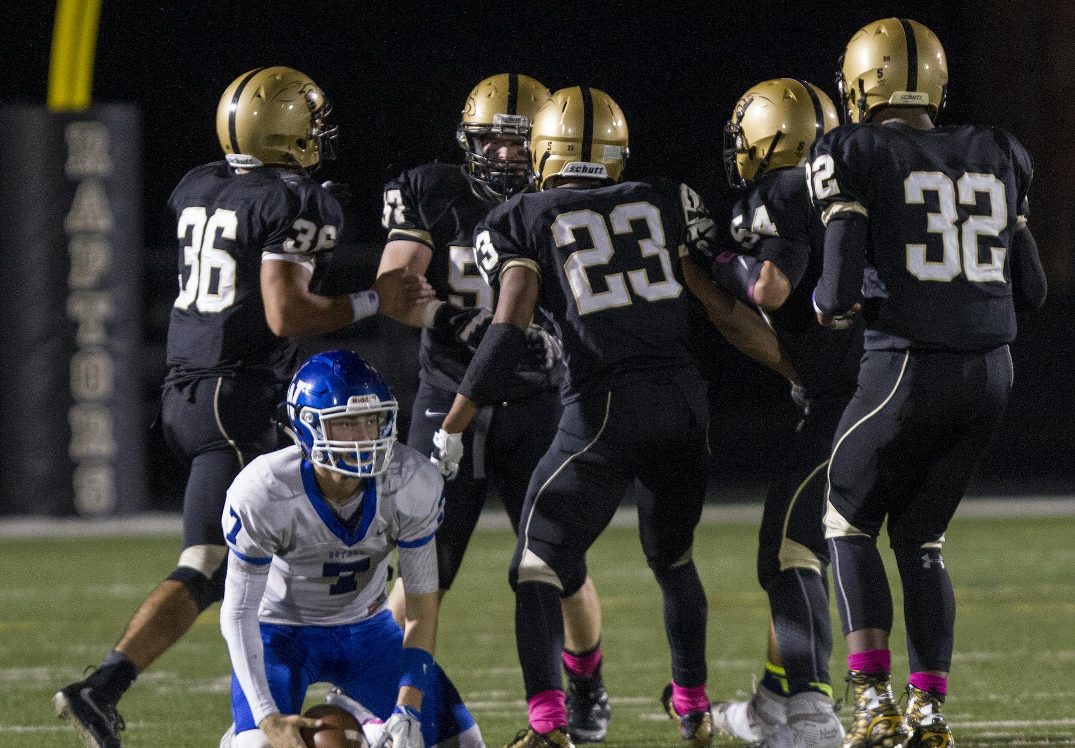 Woodbury QB 7 Brady Mundahl is sacked by a gang of Raptors as the Eastridge Raptors hosted the Woodbury Royals at the Raptor's Nest at East Ridge High School on October 9, 2015. [Special to Star Tribune Matt Blewett ï matt@mattebphoto.com 959967 20041434A SLUG: PREP101015.east]