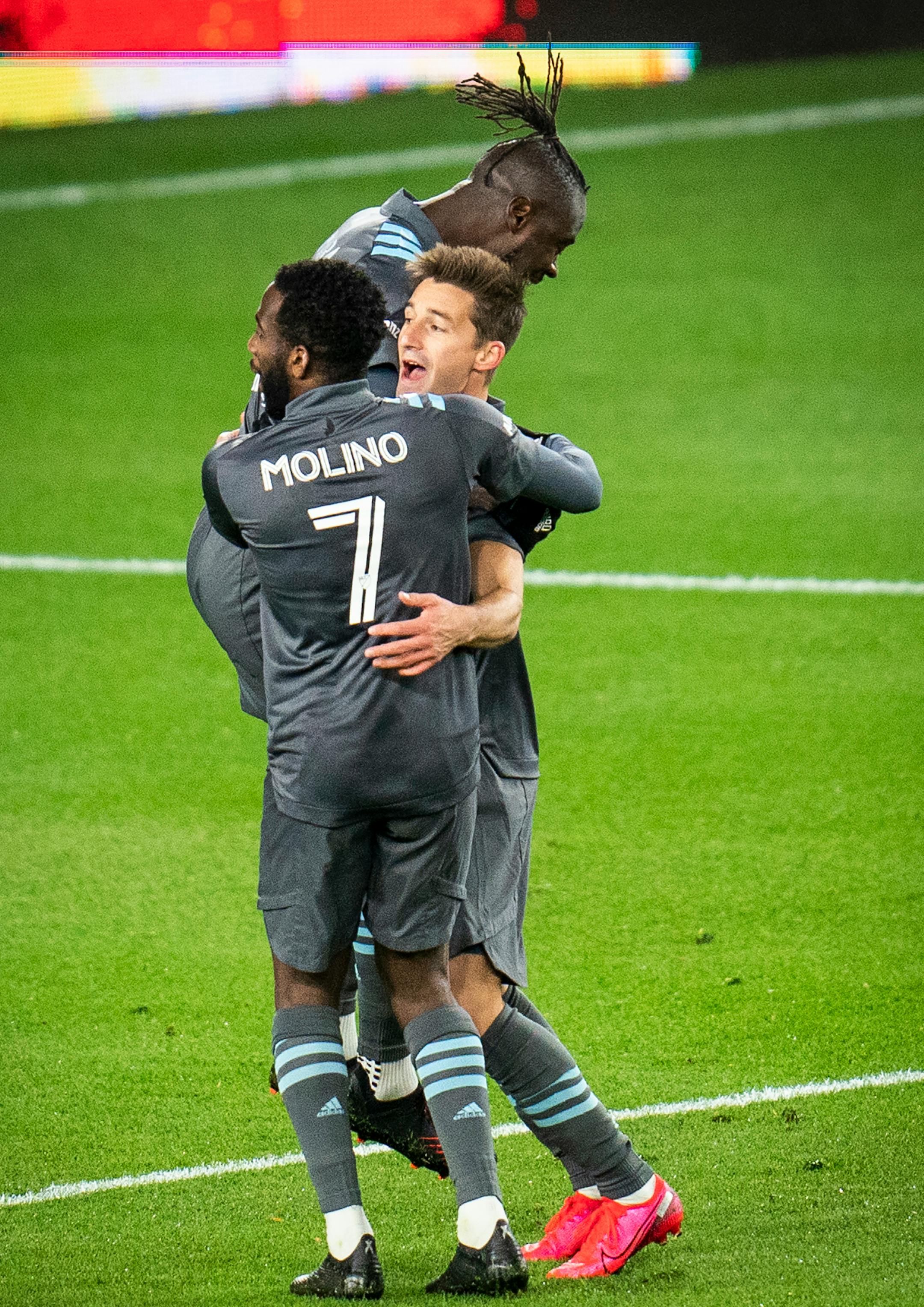 Minnesota United midfielder Ethan Finlay (13), center, celebrated with teammates Kevin Molino (7) and Kei Kamara (16) after scoring a goal during the first half.