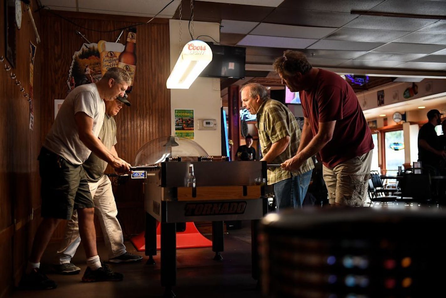 From left, Steve Zenisek, Verne LeRoy, Frank Smith and Norman Johnson played a game of foosball at Mortimer's Bar and Grill Friday.