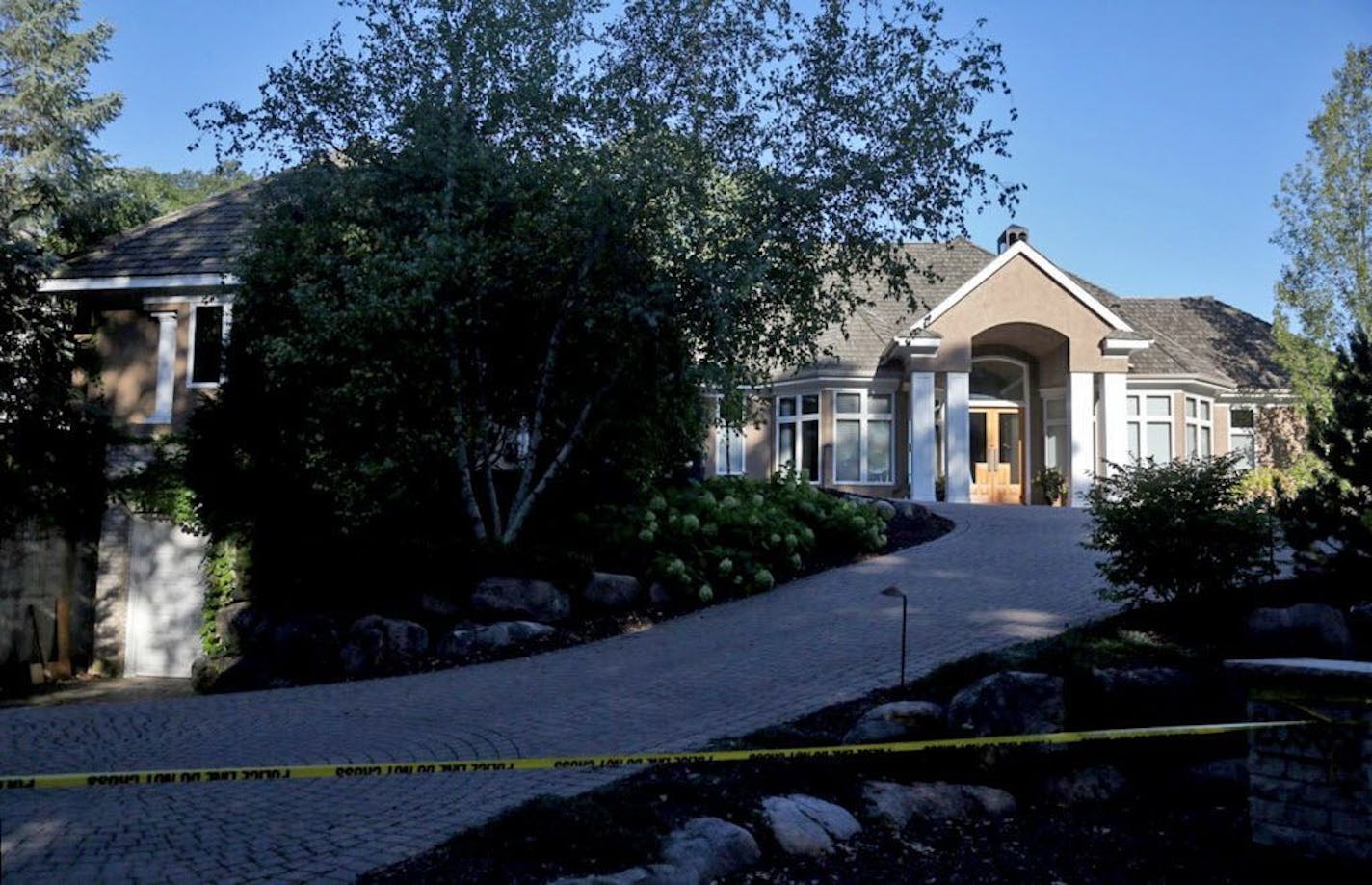 Yellow crime tape marked off the Greenwood home of the Brian and Karen Short family, where all five members of the family were discovered dead Thursday.