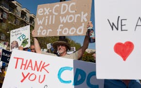 Demonstrators hold a rally in support of the Centers for Disease Control and Prevention in front of the agency's headquarters in Atlanta, Tuesday, Apr