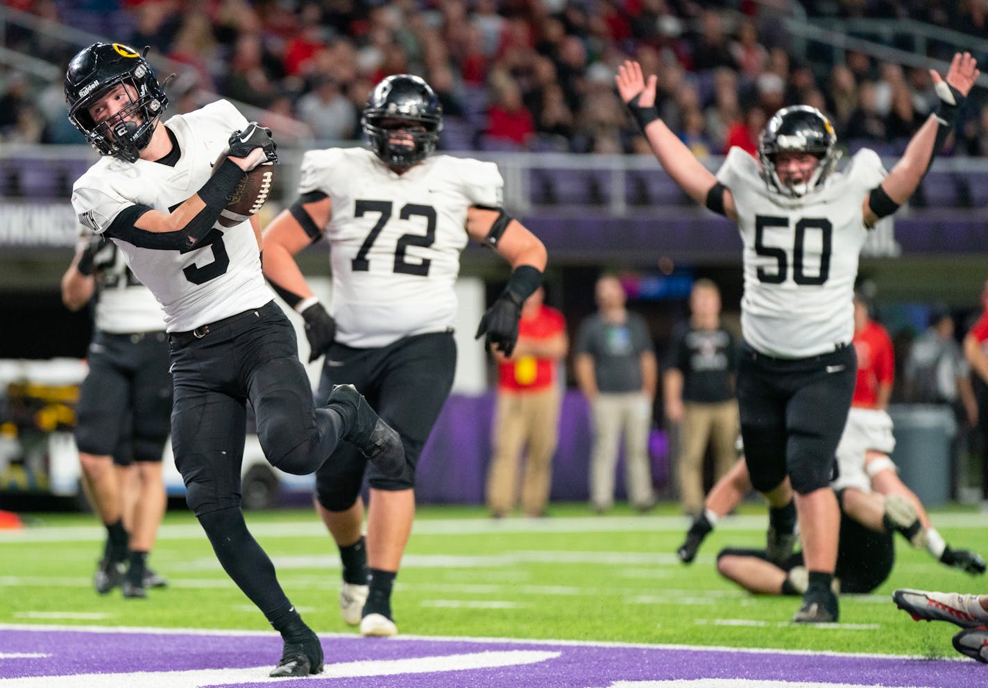 Hutchinson wide receiver Nathan Thode (5) scores a touchdown against North Branch in the second quarter of a Class 4A football semi-final game Friday, Nov. 17, 2023, at U.S. Bank Stadium in Minneapolis, Minn. ]