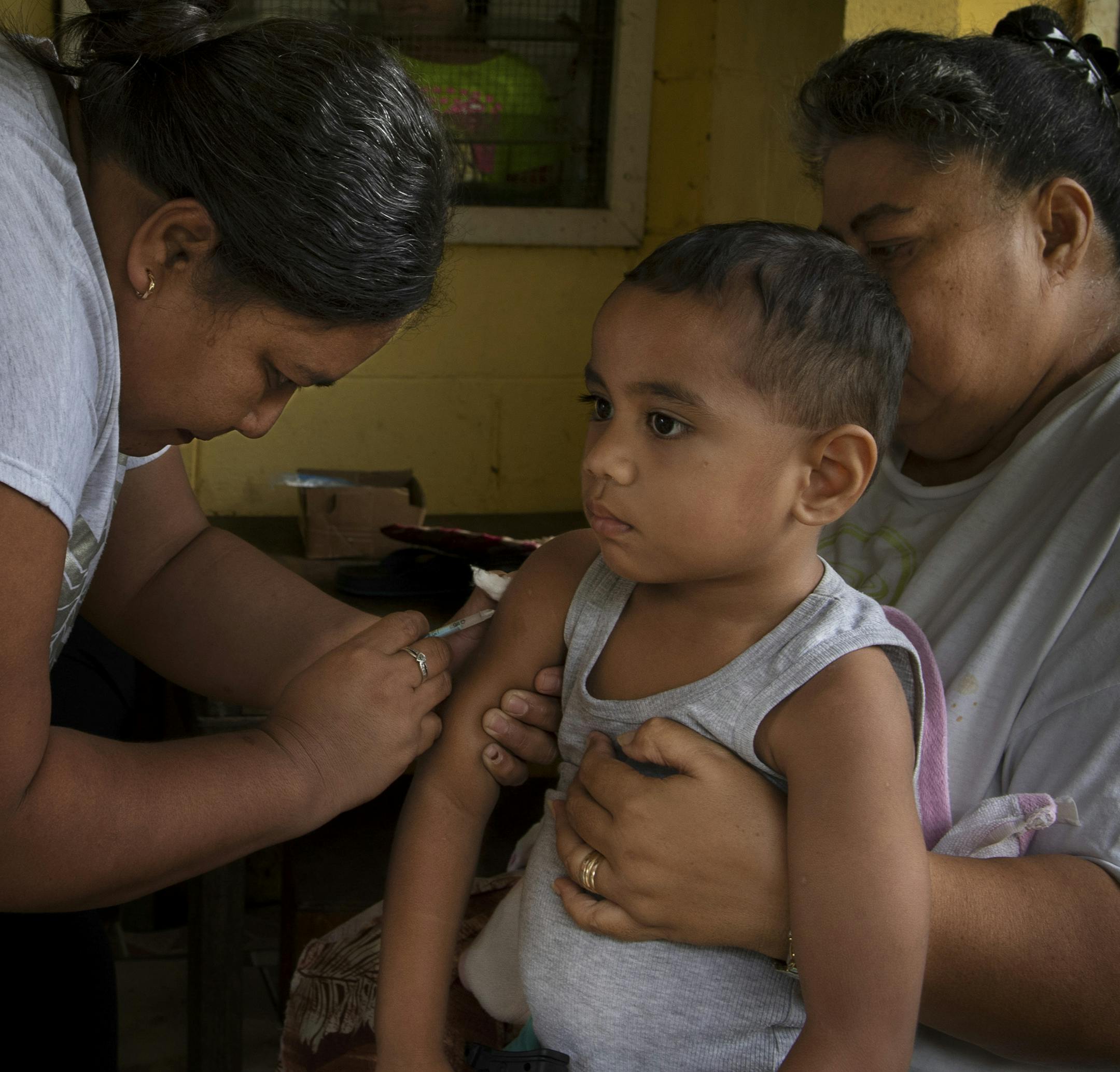 FILE -- Johan Auvele is vaccinated against the measles in his village on the outskirts of Apia, Samoa, Dec. 11, 2019. Samoa on Saturday, Dec. 28, 2019, lifted a six-week state of emergency after a measles epidemic killed at least 81 people, many of them younger than 5, in the South Pacific island nation. (Matthew Abbott/The New York Times)