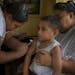 FILE -- Johan Auvele is vaccinated against the measles in his village on the outskirts of Apia, Samoa, Dec. 11, 2019. Samoa on Saturday, Dec. 28, 2019