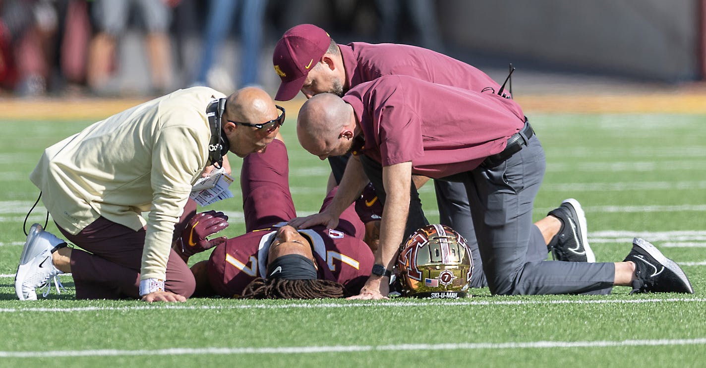 Minnesota's Head Coach P.J. Fleck, left, tends to wide receiver Chris Autman-Bell (7) after he was injured in the second quarter against Colorado at Huntington Bank Stadium in Minneapolis, Minn., on Saturday, Sept. 17, 2022. ] Elizabeth Flores • liz.flores@startribune.com