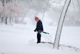 Gerard Langer braved the heavy and blowing snow to shovel in St. Cloud, MN, Friday, November 18, 2016.