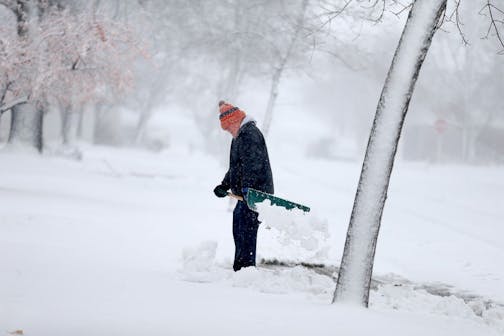 Gerard Langer braved the heavy and blowing snow to shovel in St. Cloud, MN, Friday, November 18, 2016.