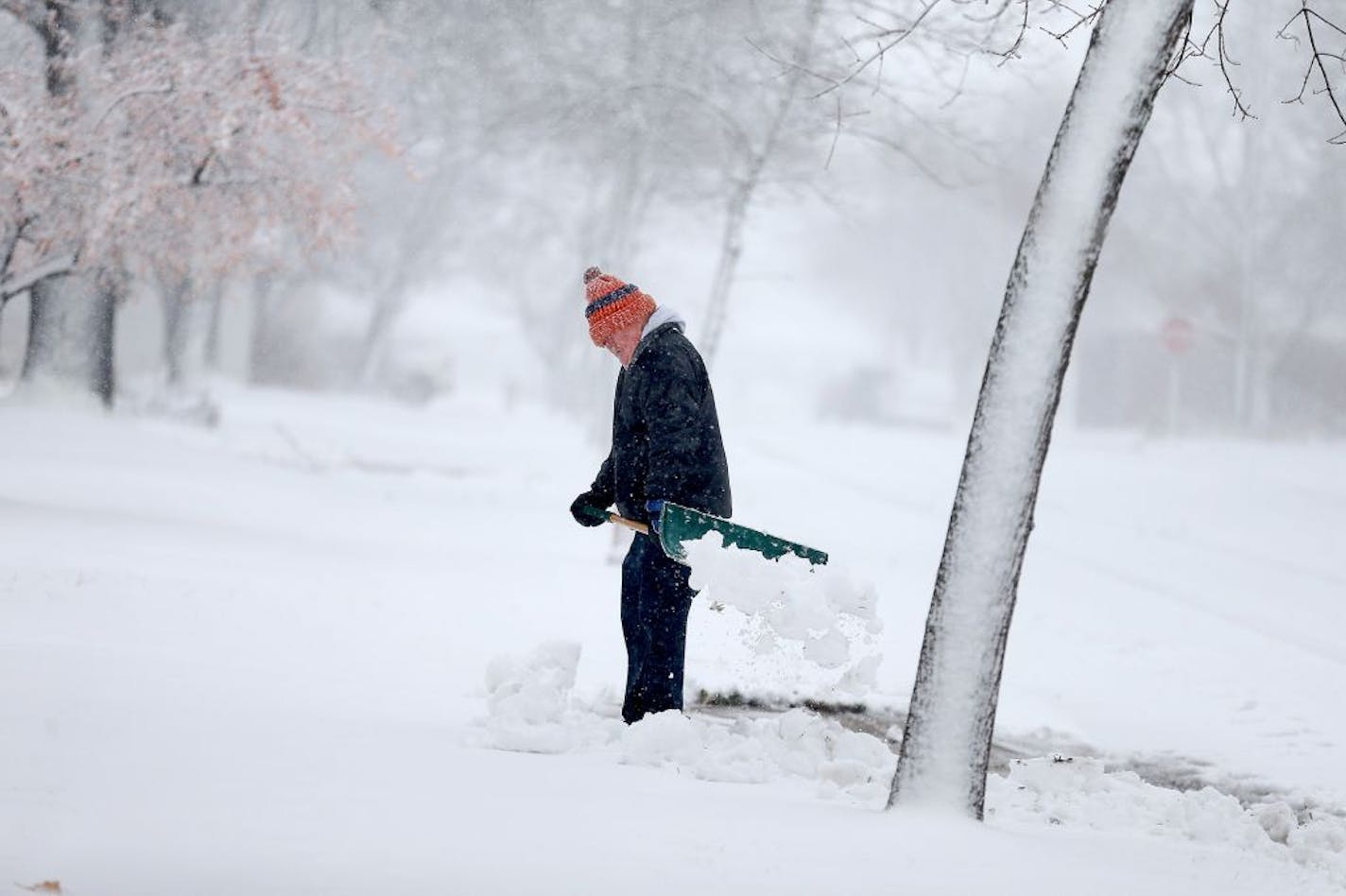 Gerard Langer braved the heavy and blowing snow to shovel in St. Cloud, MN, Friday, November 18, 2016.