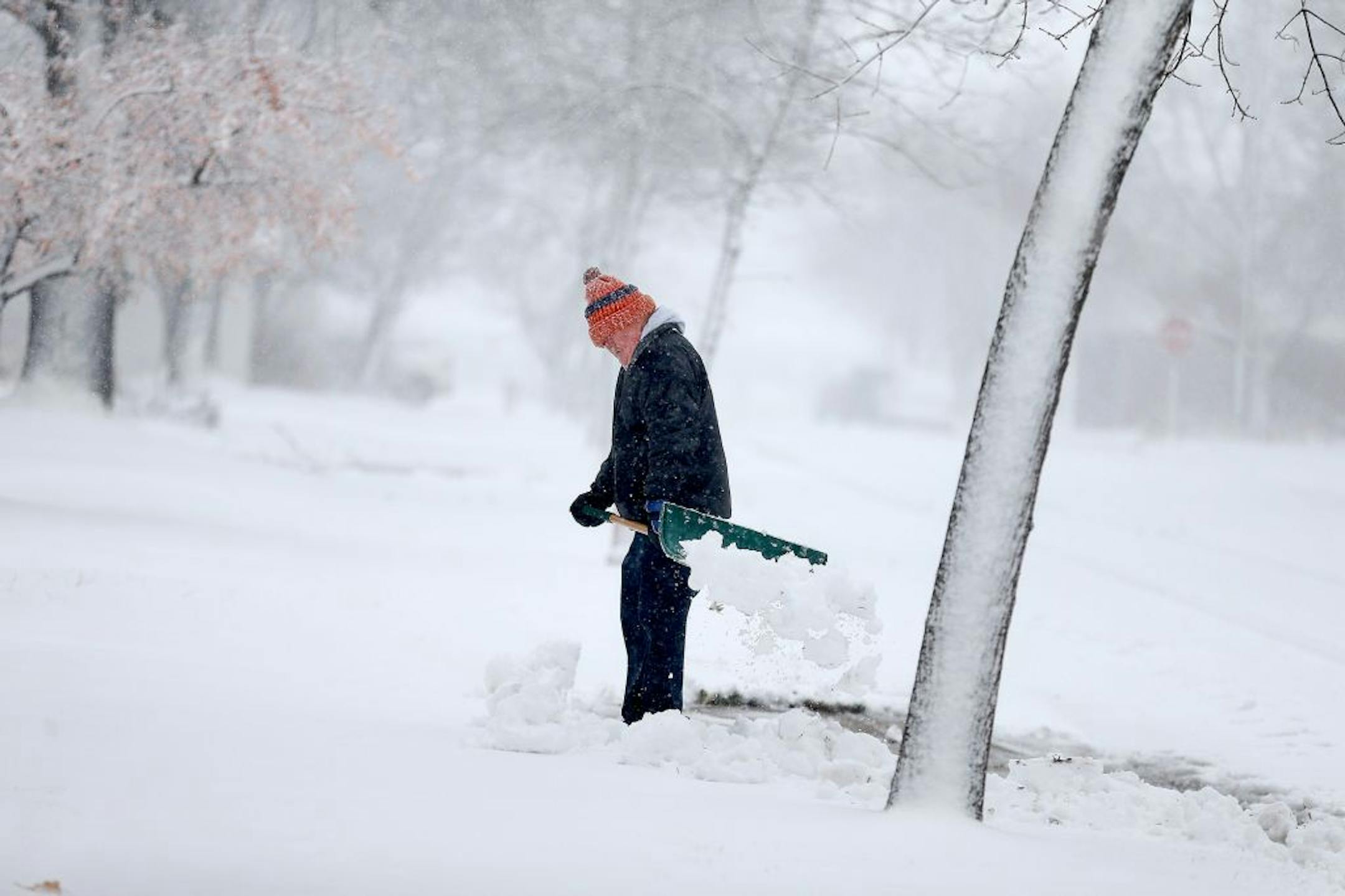 Gerard Langer braved the heavy and blowing snow to shovel in St. Cloud, MN, Friday, November 18, 2016.
