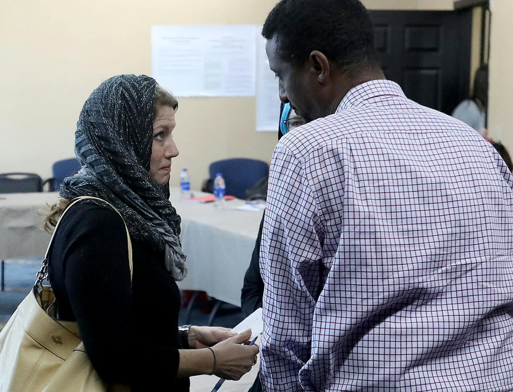 Family members of those killed in the fire sat down with Dar Al-Hijrah Mosque leaders, community leaders and volunteers and representatives of People's Center and Red Cross to discuss funds raised and help needed. Here, Ali Isse, right, staff member for U.S. Rep. Ilhan Omar, spoke with a representative of Tyler Scott Baron’s family Thursday, Dec. 5, 2019, at Dar Al-Hijrah Mosque in Minneapolis, MN.] DAVID JOLES • david.joles@startribune.com Dar Al-Hijrah mosque leaders, community l