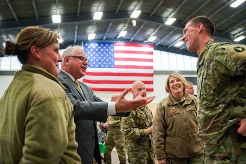 Minnesota Governor Tim Walz was happy to see Lt. Col Ryan Kelly. Kelly and Walz deployed together and now Kelly leads the unit. Walz stopped by the Minnesota National Guard holiday gathering at the joint force headquarters. Behind them on the right is Deputy Adjutant General Sandra Best.