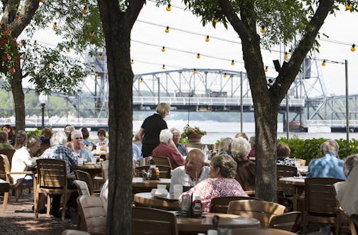 Guests dine on the patio overlooking the St. Croix River at Dock Cafe in Stillwater June 26, 2014. (Courtney Perry/Special to the Star Tribune)