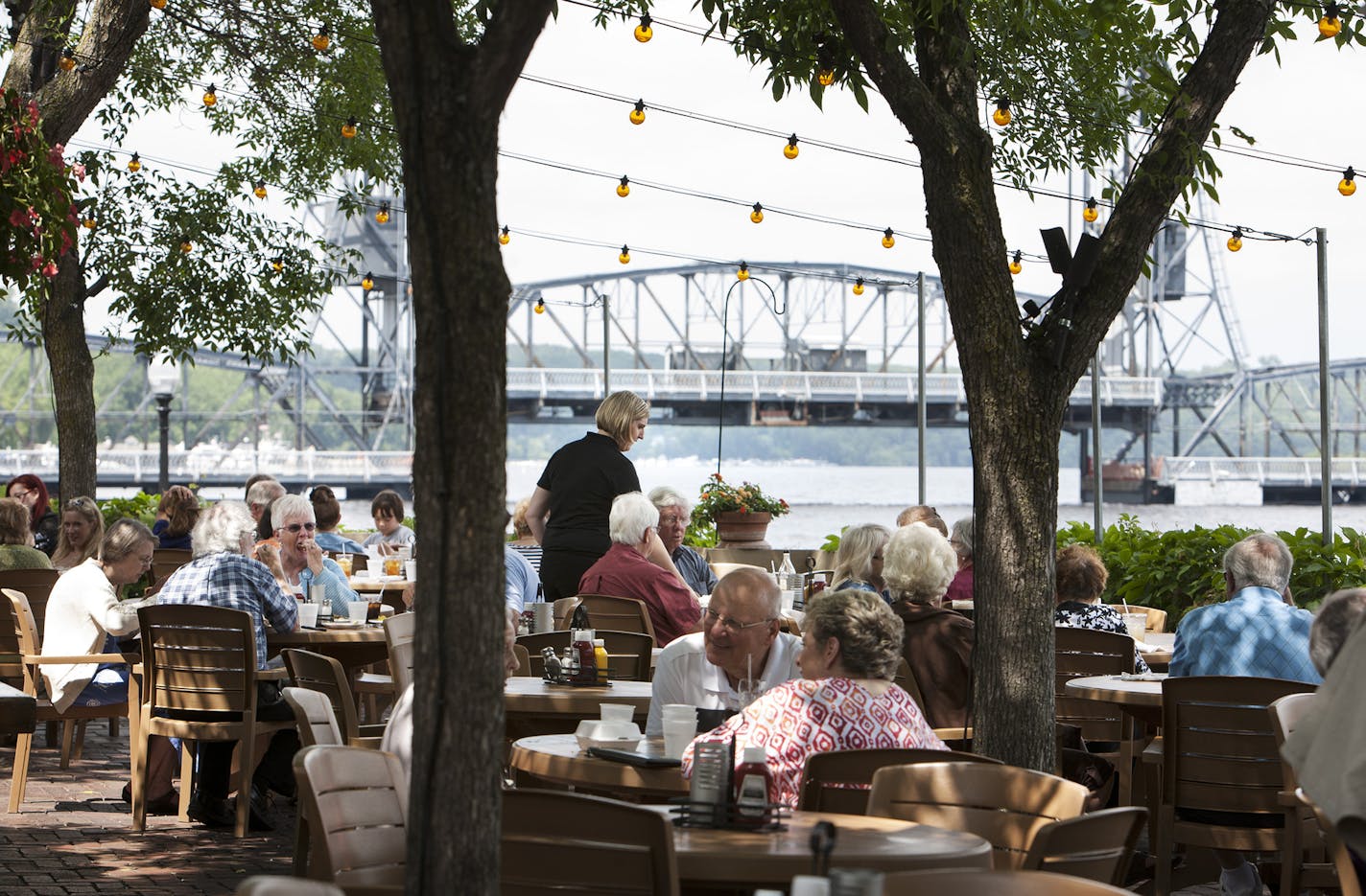 Guests dine on the patio overlooking the St. Croix River at Dock Cafe in Stillwater June 26, 2014. (Courtney Perry/Special to the Star Tribune)