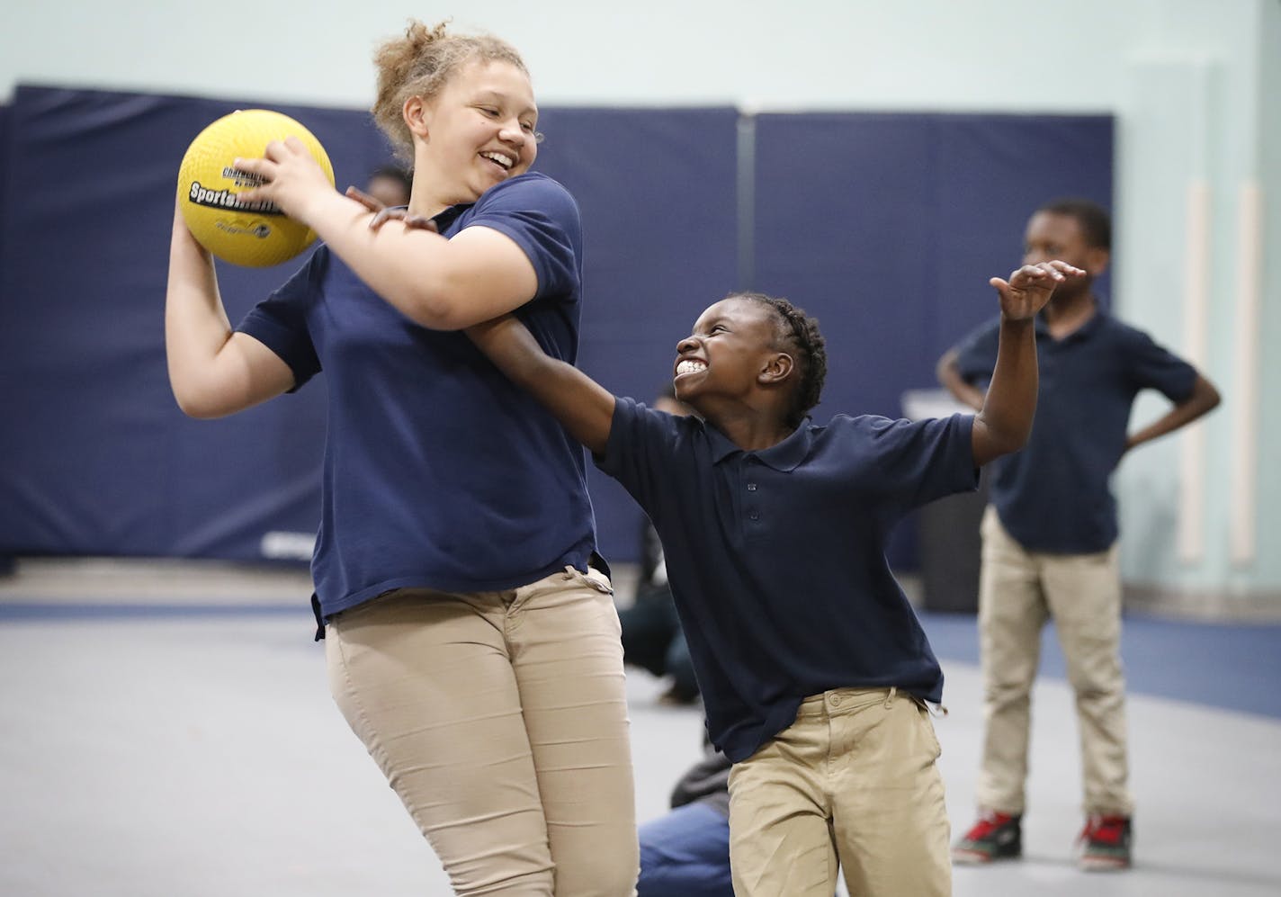 Essence Bell-Williams, left, 10, kept the ball from Helena Wheeler, 10, during after-school gym time at Plymouth Christian Youth Center in Minneapolis.