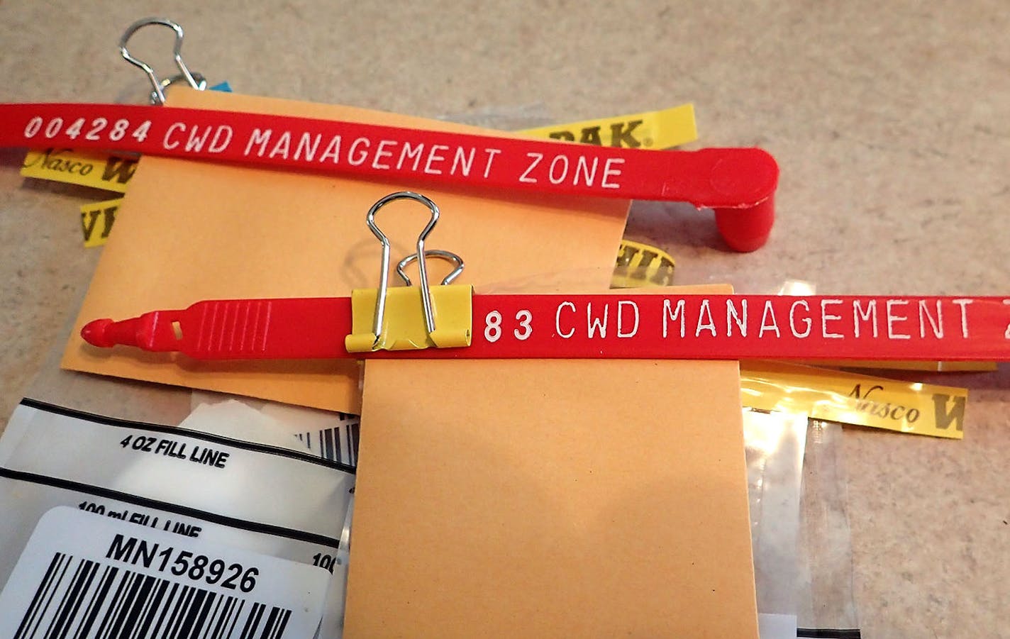 Every deer harvested in the new, north-central CWD management zone must be tagged with one of these red clips and stay within the zone until testing of tissue samples from the deer show that it is not infected with CWD. Thecorresponding bar-coded sample bags are filled with the deer's lymph nodes and sent to a lab in Colorado. There's a seven to eight-day turnaround for results to come in.