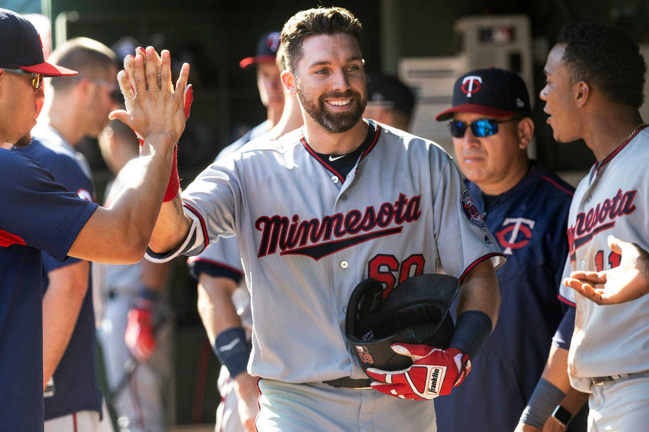 Minnesota Twins' Jake Cave (60) is congratulated by teammates after hitting a solo home run during the eighth inning against the Texas Rangers in a baseball game Sunday, Sept. 2, 2018, in Arlington, Texas. (AP Photo/Sam Hodde)