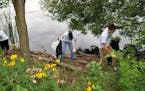 Volunteers cleaning the shoreline at Lake Hiawatha.