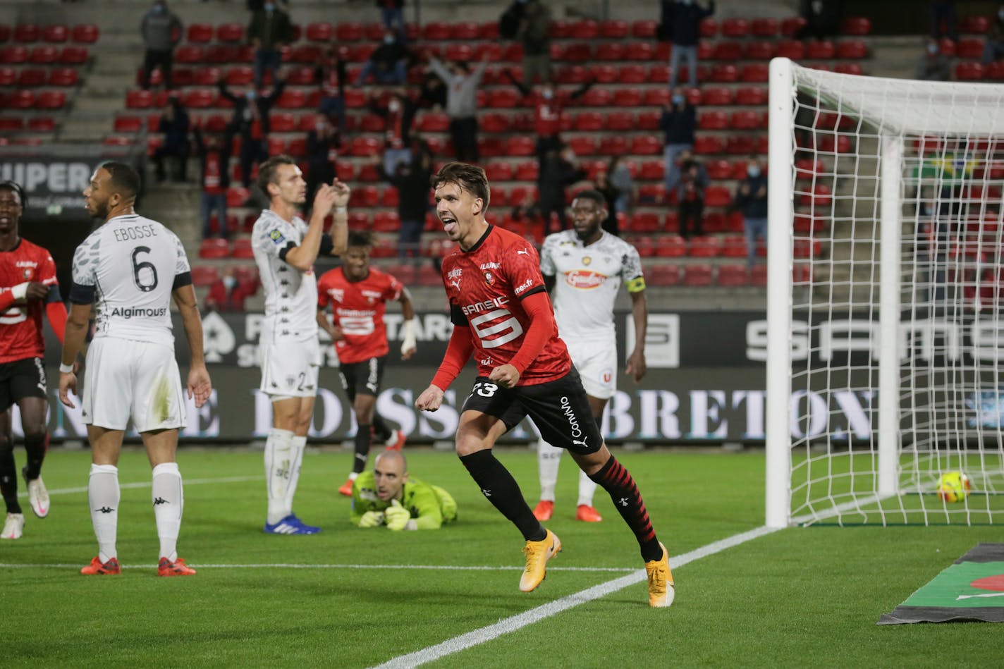 Forward Adrien Hunou of Rennes celebrates scoring the first goal during the League One soccer match between Rennes and Angers, at the Roazhon Park stadium in Rennes, France, Friday Oct. 23, 2020. (AP Photo/David Vincent)